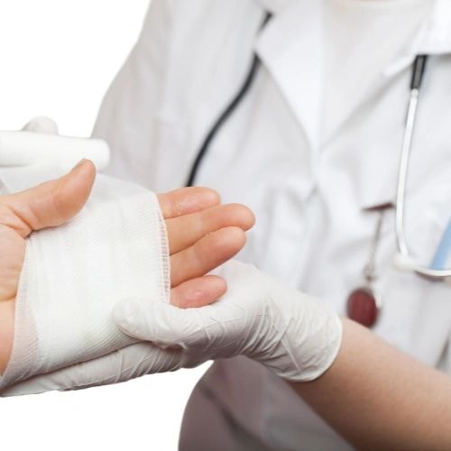 Healthcare professional carefully applying wound bandaging